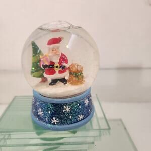 Christmas snow globe featuring caroling snowmen